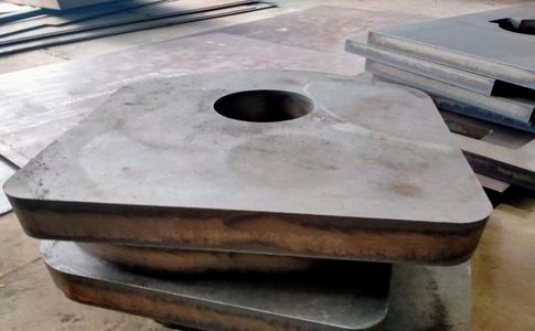 Thick block bored for a heavy machine component, cut from quenched and tempered plate