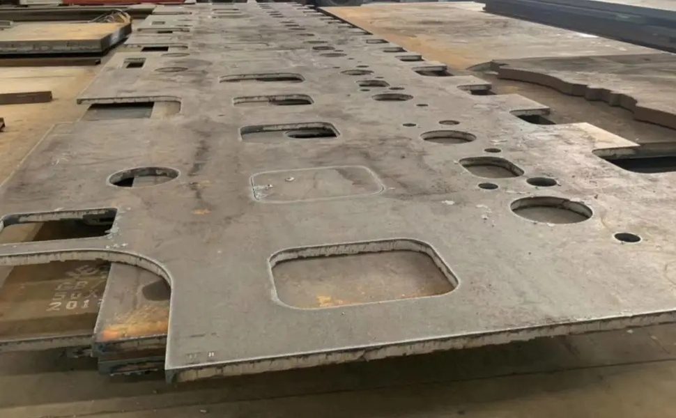 Large steel plate plasma-cut with slots and openings to a fabrication drawing